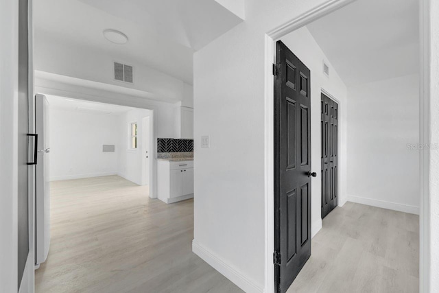 corridor featuring light hardwood / wood-style floors