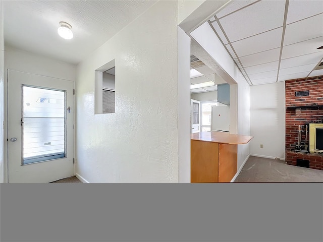 kitchen featuring white refrigerator, light carpet, a wealth of natural light, and a brick fireplace