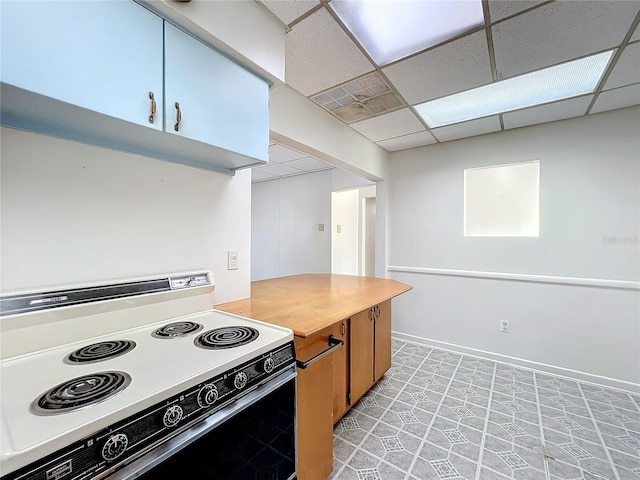 kitchen featuring white electric range oven and a paneled ceiling