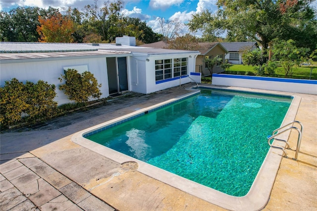 view of swimming pool featuring a patio area