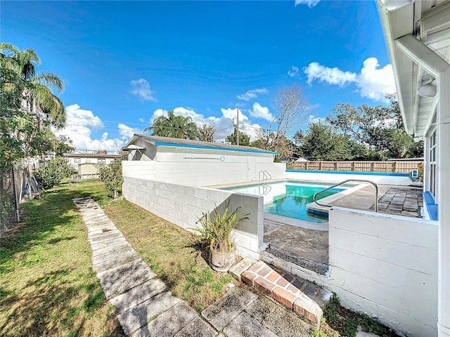 view of pool with a lawn