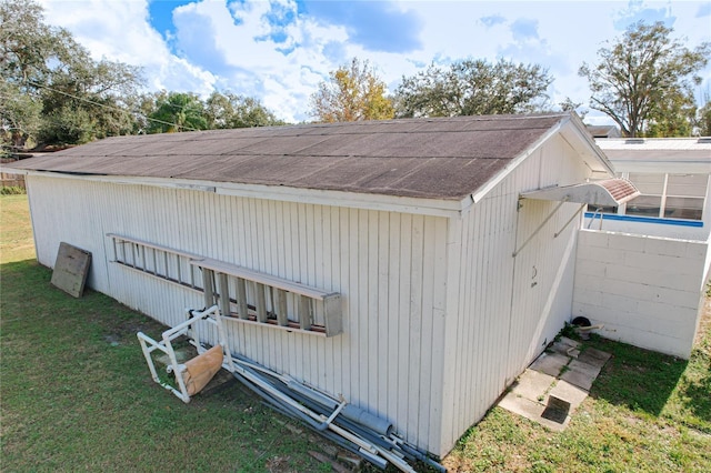 view of outbuilding featuring a lawn