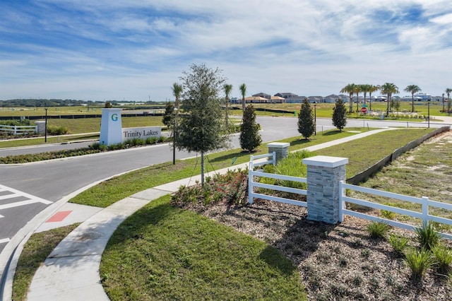 view of property's community with a lawn