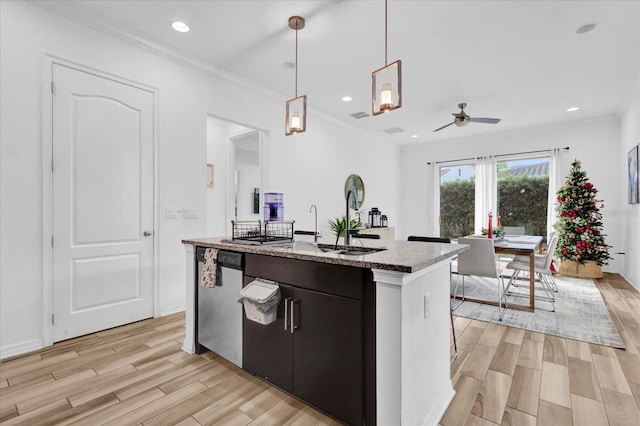 kitchen featuring ceiling fan, stainless steel dishwasher, light wood-type flooring, decorative light fixtures, and ornamental molding