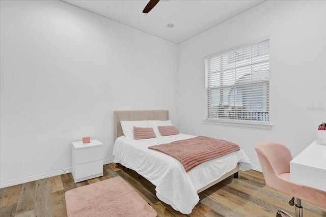 bedroom with ceiling fan and wood-type flooring