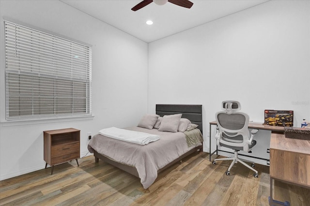 bedroom with hardwood / wood-style flooring and ceiling fan