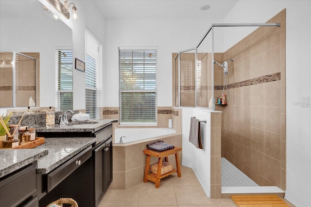 bathroom featuring vanity, plenty of natural light, plus walk in shower, and tile patterned flooring