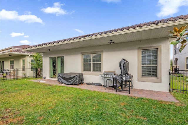 rear view of house with a lawn and a patio area