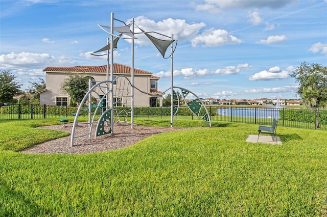 view of playground featuring a yard and a water view