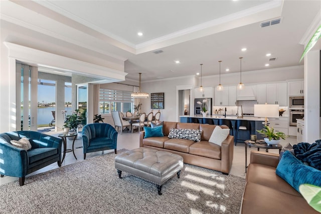 living room featuring a water view and crown molding