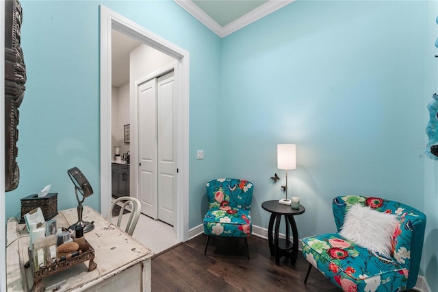 living area featuring hardwood / wood-style floors and ornamental molding