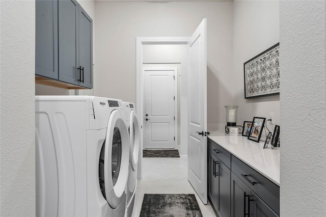 laundry room with cabinets and washing machine and dryer