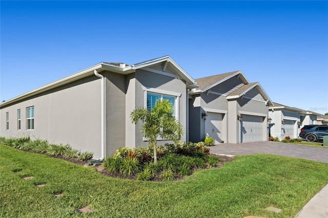 view of front facade with a front yard and a garage