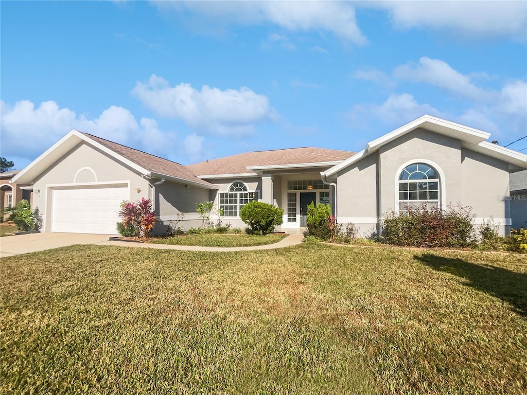 ranch-style house featuring a front yard and a garage