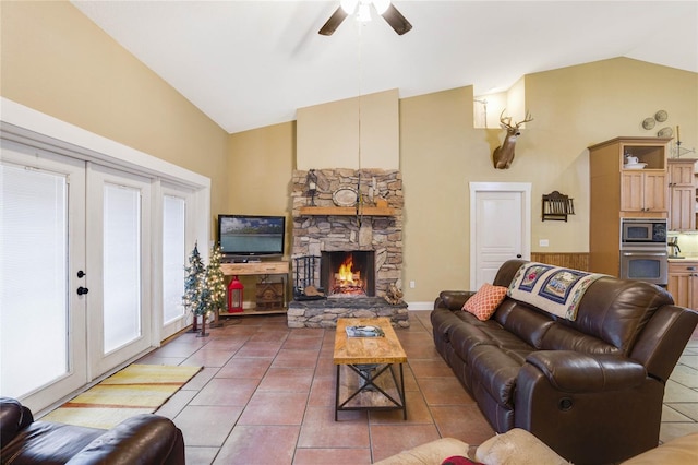 living room featuring tile patterned floors, ceiling fan, a fireplace, and french doors