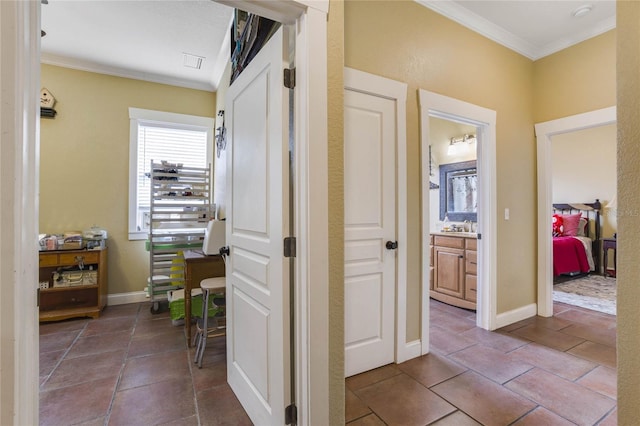 hallway featuring crown molding and tile patterned flooring