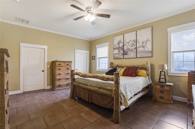 tiled bedroom with ceiling fan and ornamental molding