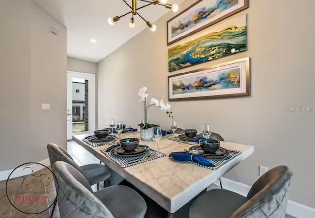 dining area featuring a chandelier and lofted ceiling