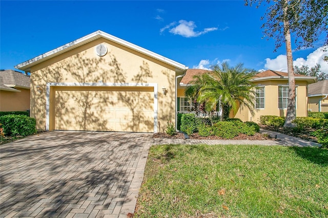 view of front of house featuring a front yard and a garage