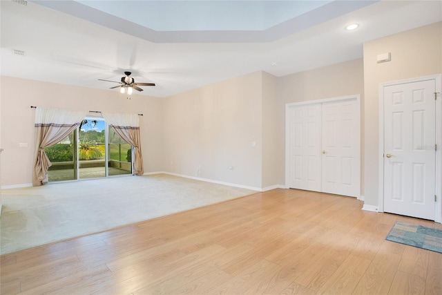 spare room featuring light colored carpet and ceiling fan