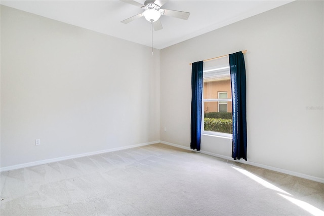 empty room featuring light carpet and ceiling fan