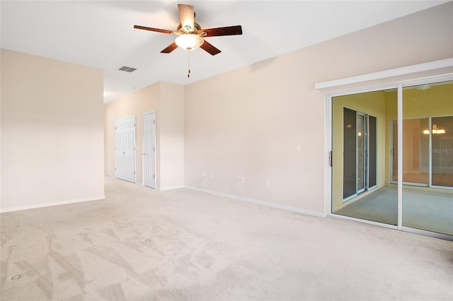 empty room featuring ceiling fan and light colored carpet