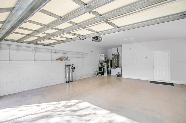 garage featuring electric water heater, a garage door opener, and heating unit