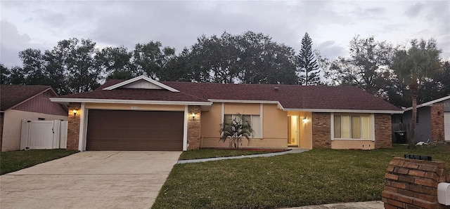 ranch-style home featuring a front lawn and a garage