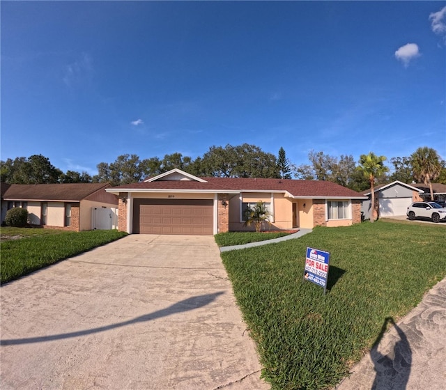 ranch-style house with a garage and a front yard