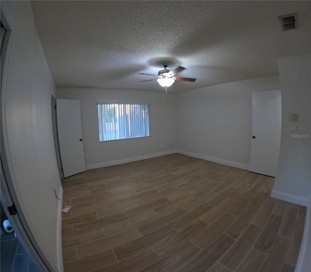 1859 Lake Hill Cir, Orlando, FL 32818 - spare room featuring a ceiling fan, wood finished floors, and a textured ceiling