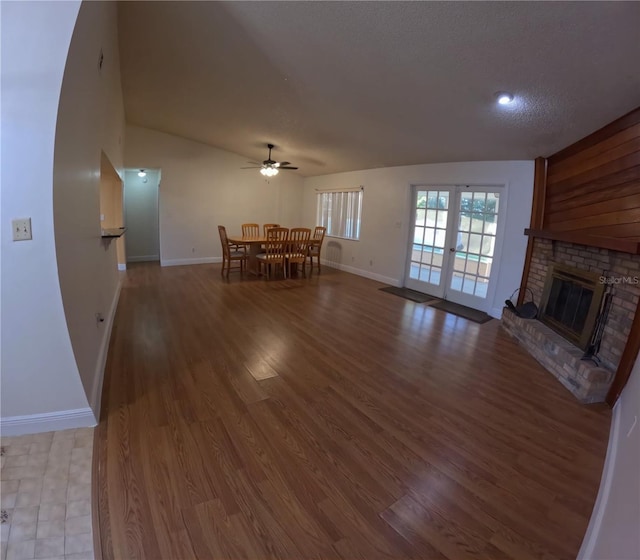 1859 Lake Hill Cir, Orlando, FL 32818 - living area featuring ceiling fan, lofted ceiling, a brick fireplace, and wood finished floors