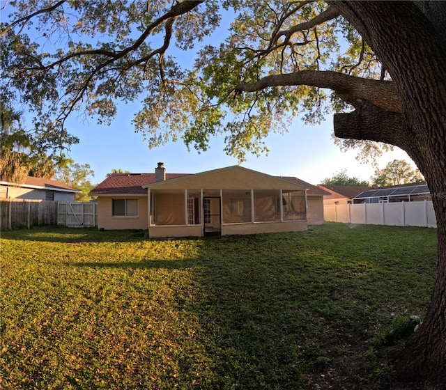 1859 Lake Hill Cir, Orlando, FL 32818 - rear view of property with a sunroom, a fenced backyard, and a chimney