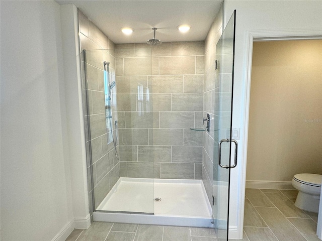 bathroom featuring toilet and walk in shower