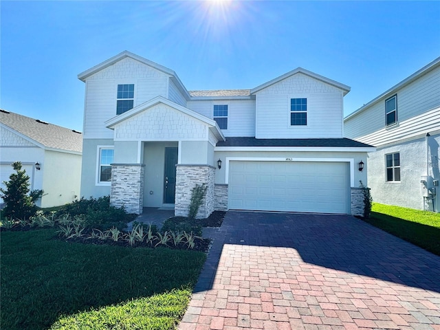 view of front of house with a front yard and a garage