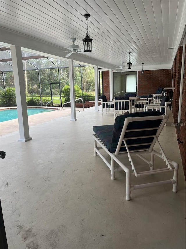 view of patio / terrace featuring glass enclosure and ceiling fan