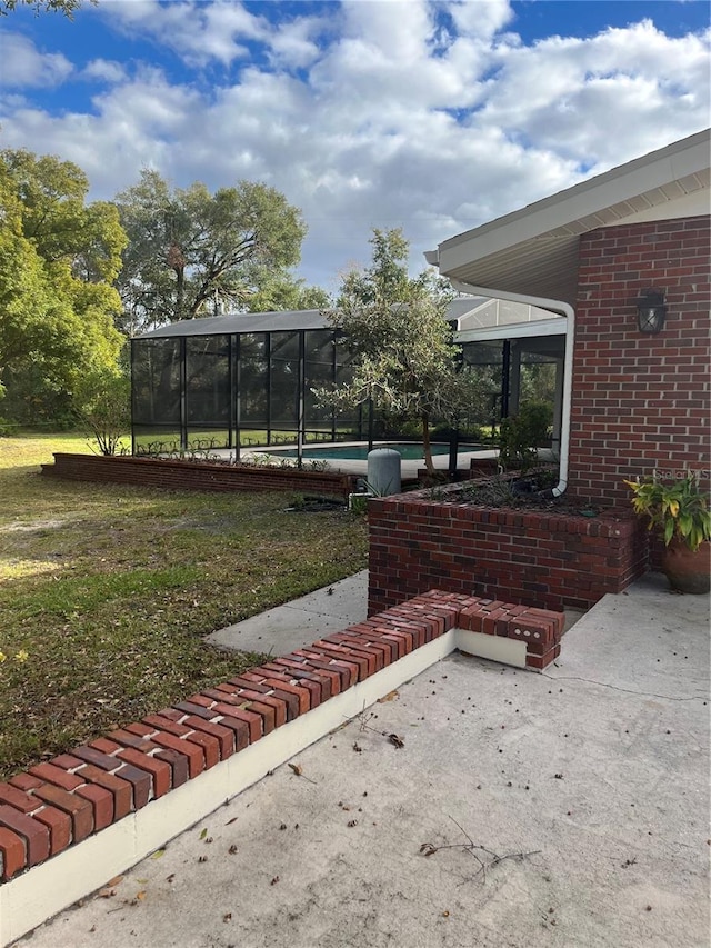 view of yard with a sunroom and a patio area