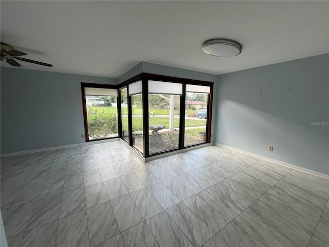 spare room with ceiling fan and a healthy amount of sunlight