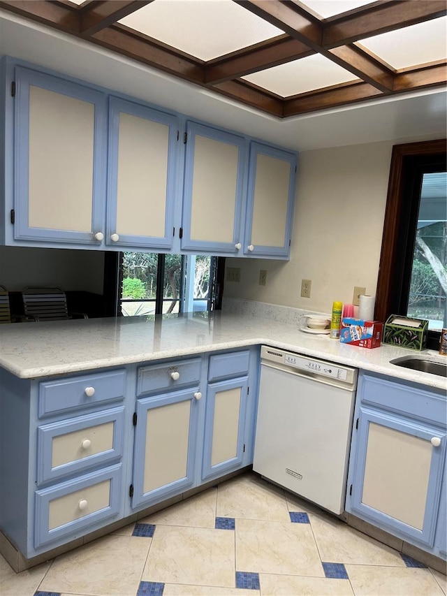 kitchen with white dishwasher, a healthy amount of sunlight, kitchen peninsula, and blue cabinetry