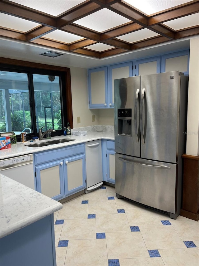 kitchen featuring white dishwasher, stainless steel fridge, sink, and coffered ceiling