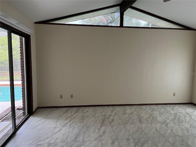 spare room with vaulted ceiling with beams