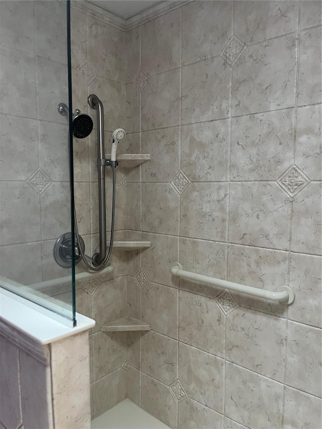 bathroom with tiled shower