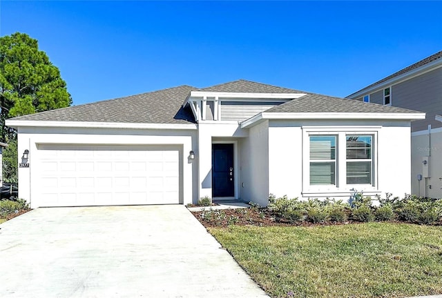 view of front of home featuring a front yard and a garage