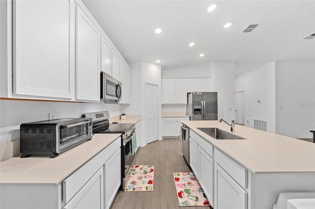 kitchen featuring white cabinetry, sink, and appliances with stainless steel finishes