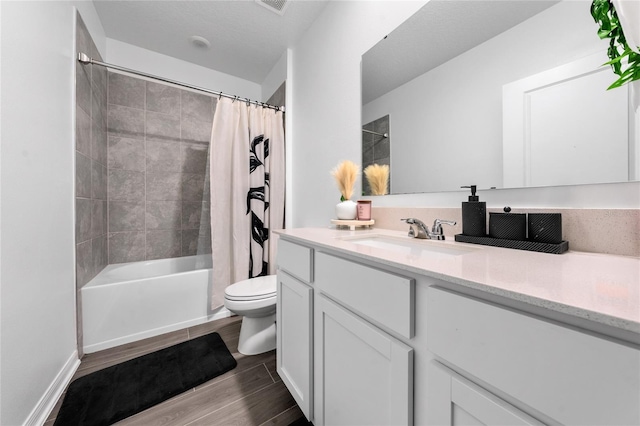 full bathroom featuring shower / tub combo, vanity, hardwood / wood-style flooring, and toilet