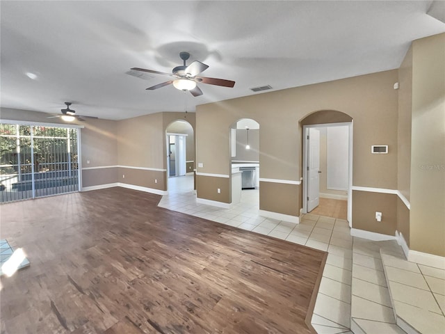 unfurnished living room featuring light wood-type flooring and ceiling fan