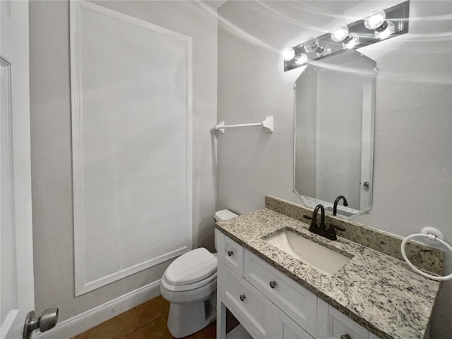 bathroom with tile patterned floors, vanity, and toilet