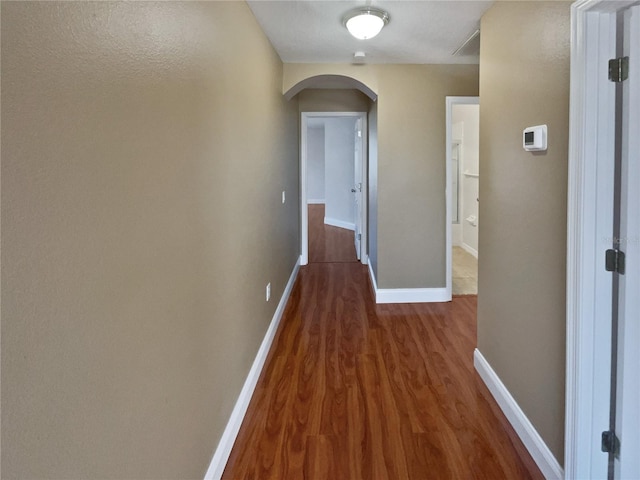 hallway with dark hardwood / wood-style flooring