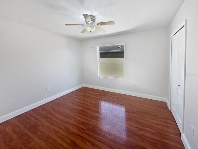 unfurnished bedroom featuring ceiling fan, dark wood-type flooring, and a closet