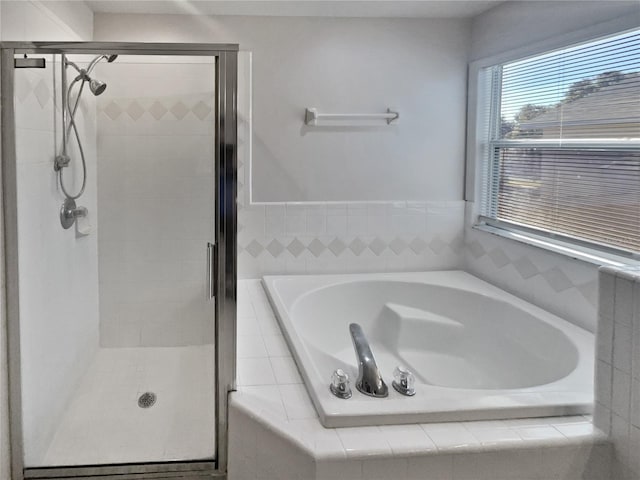 bathroom featuring separate shower and tub