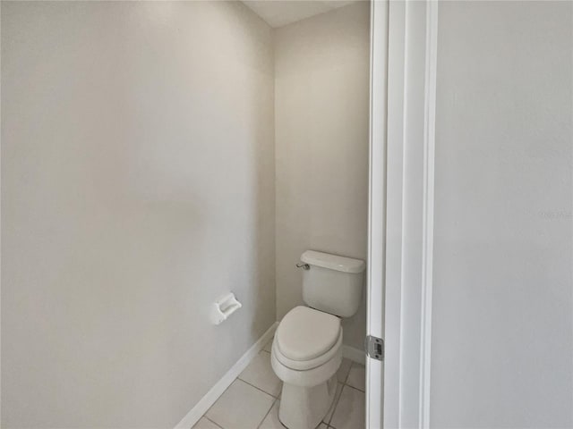 bathroom with tile patterned flooring and toilet